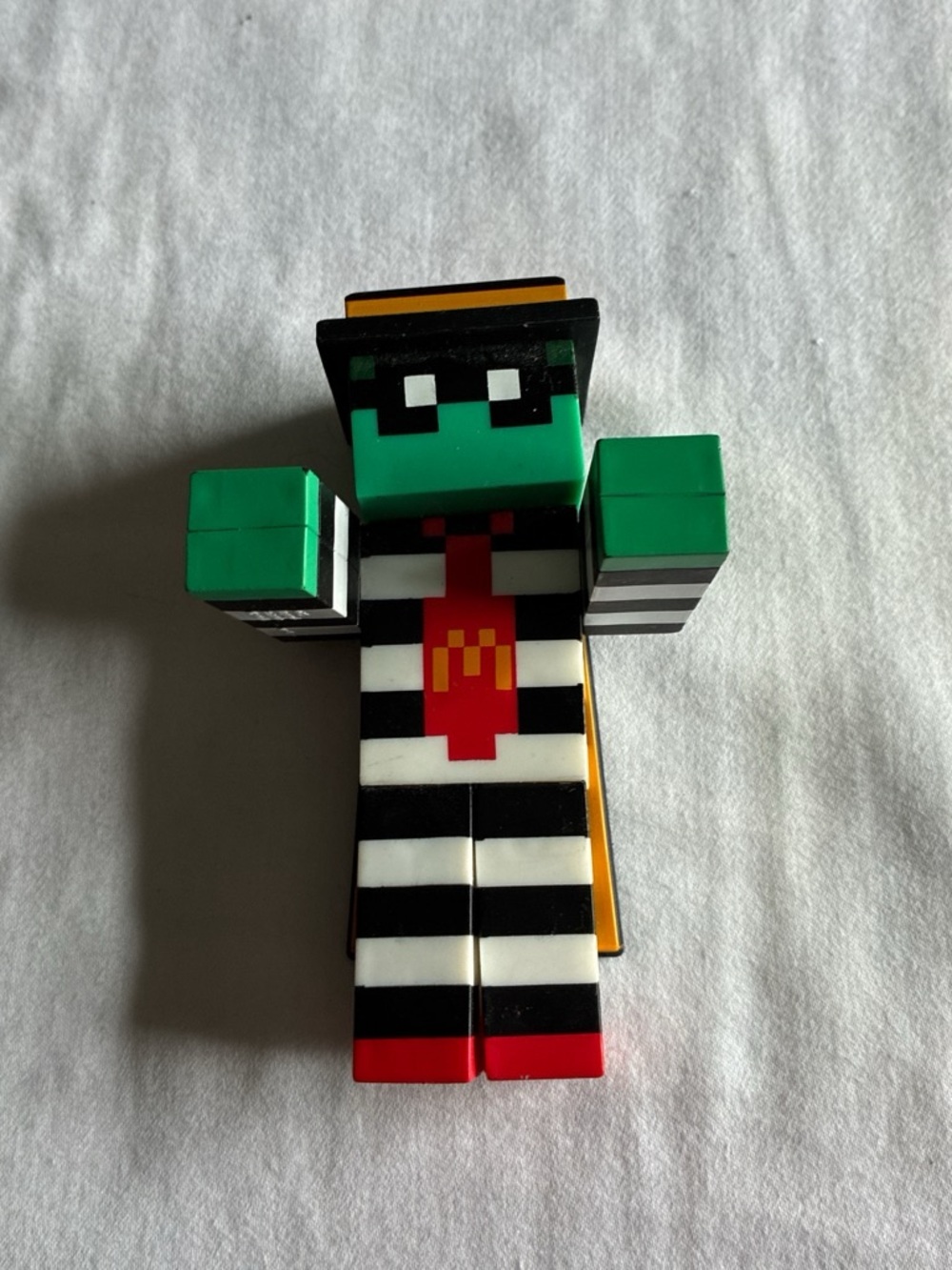 Minecraft Green Pixel Figure with Black & White Stripes and Red Tie Accent